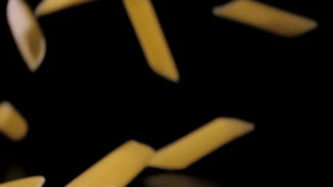 Pasta Penne Falling Down black background, slow motion Stock Footage 112452437