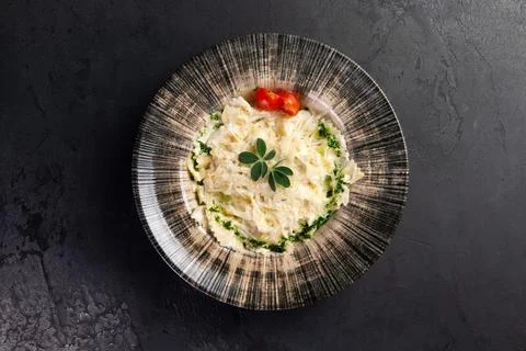 Pasta in a plate on a dark background. Stock Photos