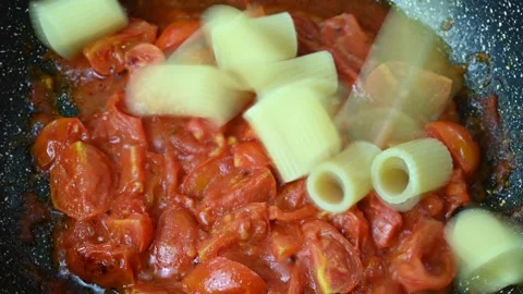 Pasta, preparing half rigatoni with tomato sauce. Stock Footage 145643244