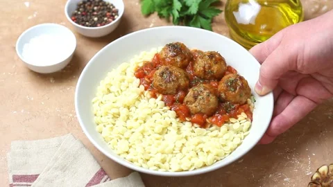 Pasta ptitim with meatballs in tomato sauce. Italian cuisine. Stock Footage 326047553
