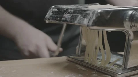 Pasta is pushed through a pasta maker Stock Footage 149111844