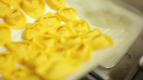 Pasta Ripiena being deep fried with basket strainer Stock Footage 107568737