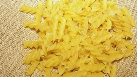 Pasta on sacking, while rotating, close-up.slow motion Stock Footage 71999312