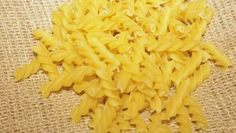 Pasta on sacking, while rotating, close-up.slow motion Stock Footage 73725770