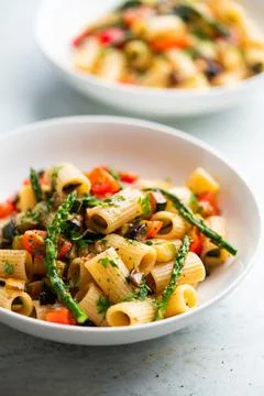 Pasta salad with grilled vegetables, zucchini, eggplant, asparagus and tomatoes. Stock Photos