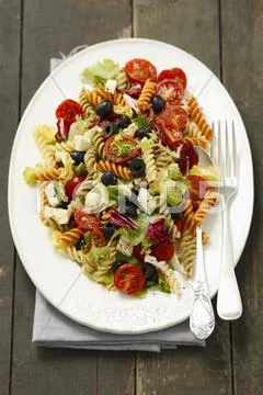 Pasta Salad With Olives, Cherry Tomatoes, Iceberg Lettuce And Mozzarella