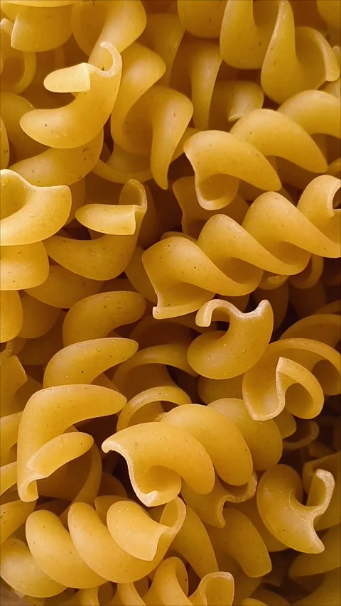 Pasta in the shape of a spiral closeup. Stock Footage 311975293