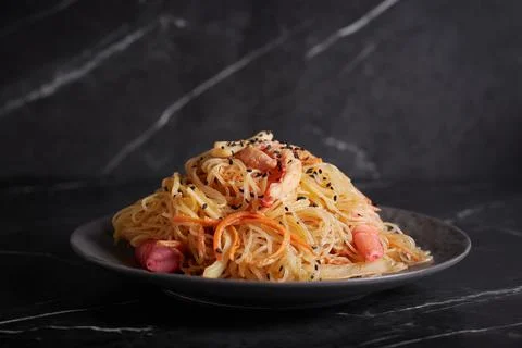 Pasta with shrimp and seafood, spaghetti, noodles, plate on a dark background Stock Photos
