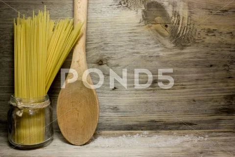 Pasta Spaghetti And Wooden Spoon On A Wooden Background