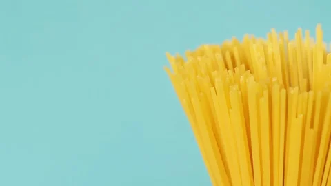 Pasta Spaghetti Close-up on a blue background rotates Video stock 202740186