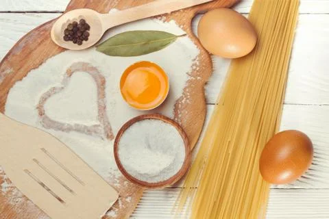 Pasta spaghetti with flour, egg on rustic wooden  background Stock Photos