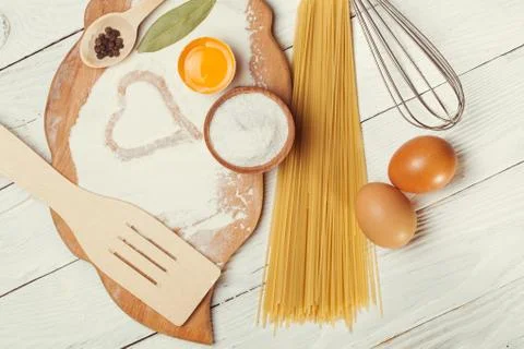Pasta spaghetti with flour, egg on rustic wooden  background Stock Photos