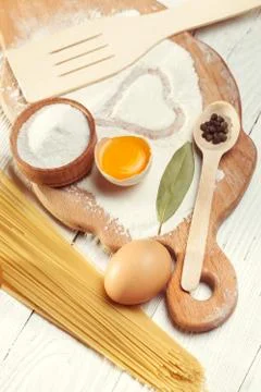 Pasta spaghetti with flour, egg on rustic wooden  background Stock Photos
