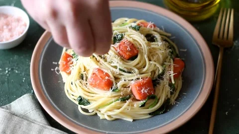 Pasta spaghetti with salmon, spinach, and cheese. Italian cuisine. Stock Footage 318868630
