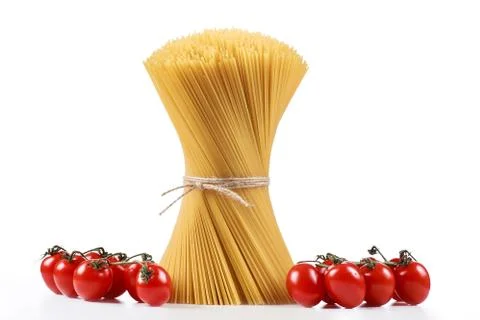 Pasta spaghetti on a white background with fresh tomatoes Stock Photos