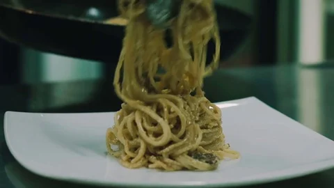 Pasta is spread from a frying pan close-up Stock Footage 76581162