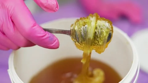 Pasta for Sugaring and Hand of  Master, Close-up. Master Takes Paste for Sugarin Stock Footage 164290055