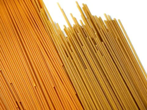 Pasta on the table. Spaghetti of two types on a white background. Tomato and  Stock Photos