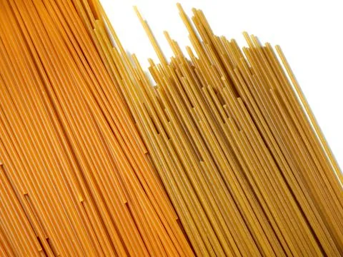 Pasta on the table. Spaghetti of two types on a white background. Tomato an.. Stock Photos