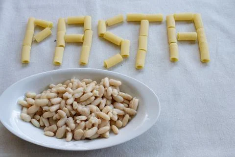 Pasta text with white beans dish Stock Photos