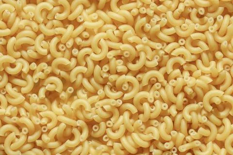 Pasta texture, uncooked macaroni Stock Photos