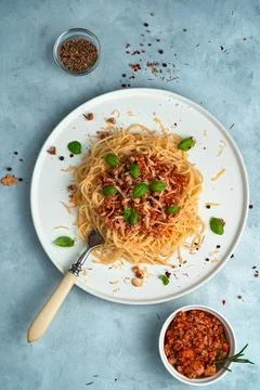 Pasta with thick sauce on a gray background. Top view, vertical orientation. Stock Photos