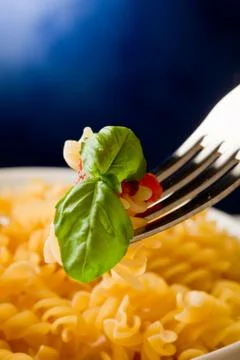 Pasta with tomato sauce and basil on blue background Stock Photos