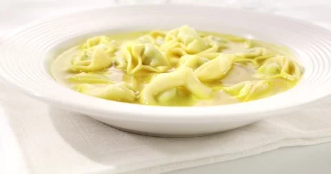 Pasta Tortelloni in chicken broth. Angle view. Slide camera movement. Stock Footage 242500268