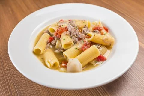Paste with lamb on white palat Stock Photos