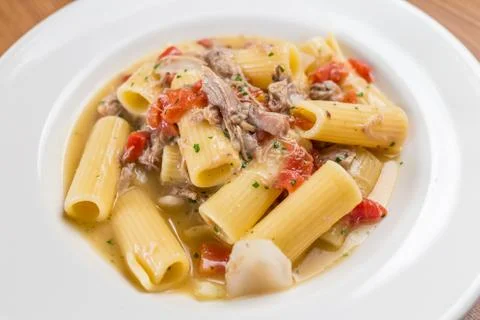 Paste with lamb on white palat Stock Photos