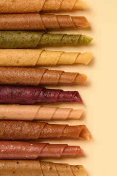 Paste. Pattern of various pastila fruit leather rolls with fruit on a beige back Stock Photos