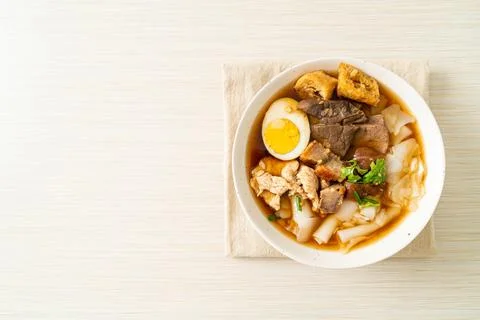 Paste of rice flour or boiled Chinese pasta square in clear soup Stock Photos