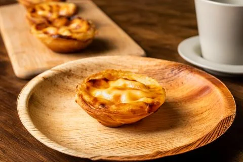Pasteis de nata, a typical sweet from Lisbon, Portugal, a cake on a plate n.. Stock Photos