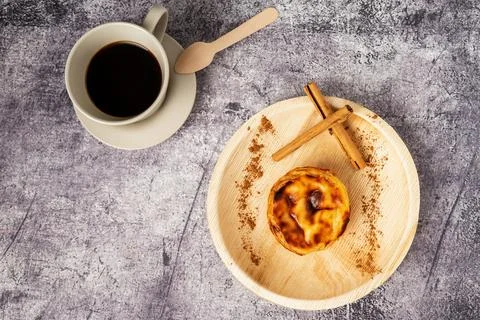 Pasteis de nata, typical sweet from Lisbon, Portugal, next to a cup of coff.. Stock Photos