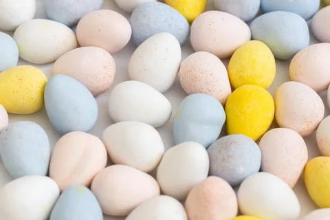 Pastel candy coated chocolate Easter eggs. Stock Photos