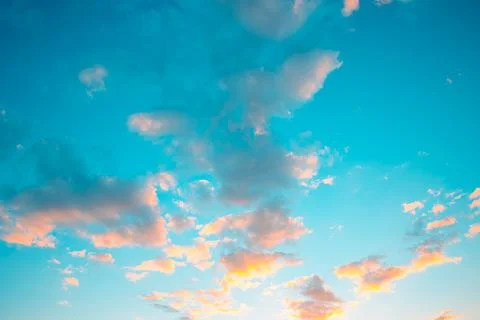 Pastel clouds at sunset. Soft colored clouds at sunset or sunrise. Stock Photos