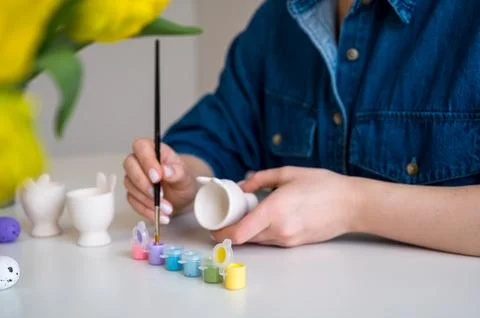 Pastel color Easter egg holder. Woman preparing for spring holiday Stock Photos