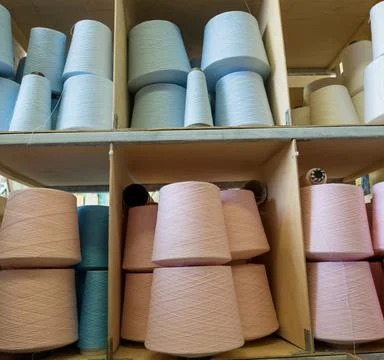 Pastel color thread spools at knitting factory view Stock Photos