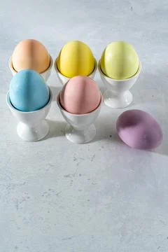 Pastel colored easter egg assortment in white cups Stock Photos