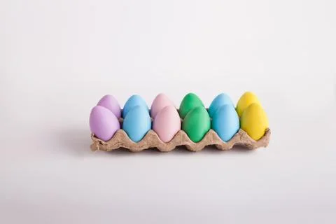 Pastel colored Easter eggs in a egg carton Stock Photos