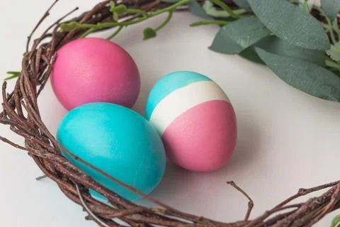 Pastel colored Easter eggs on white table Stock Photos