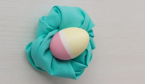 Pastel colored Easter eggs on white table Foto stock