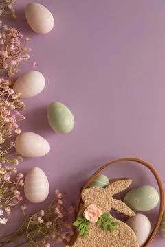 Pastel Easter Bunny Basket with Eggs and Flowers on Lavender Background Stock Photos