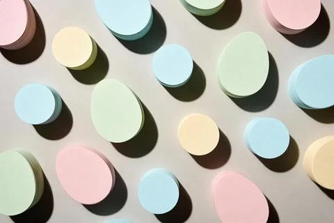 Pastel Easter eggs and circles arranged in a repeating pattern with shadows Stock Photos