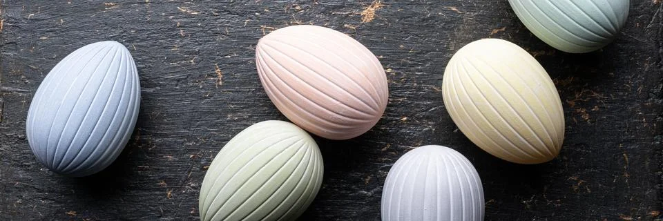 Pastel Easter eggs banner on dark rustic Stock Photos