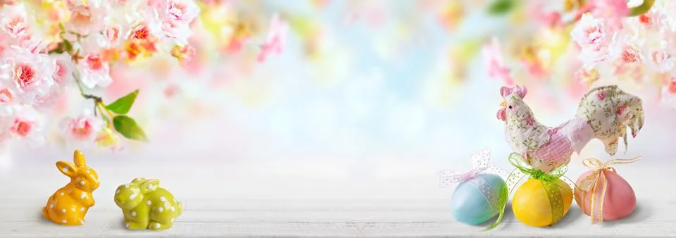 Pastel Easter scene featuring ceramic bunnies, decorated eggs with ribbons,.. Stock Photos