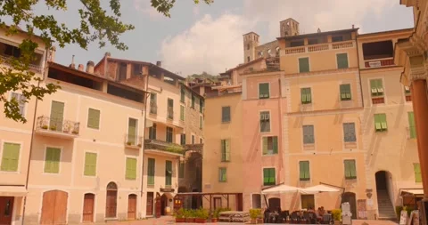 Pastel facades and small square in quaint Italian hill town Stock Footage 342356705