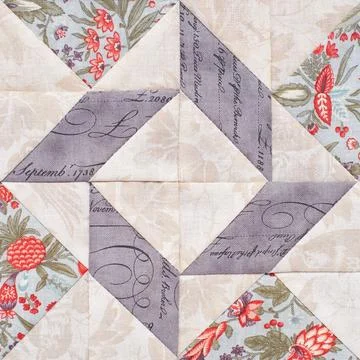 Pastel geometric patchwork block from pieces of fabrics, detail of quilt Stock Photos