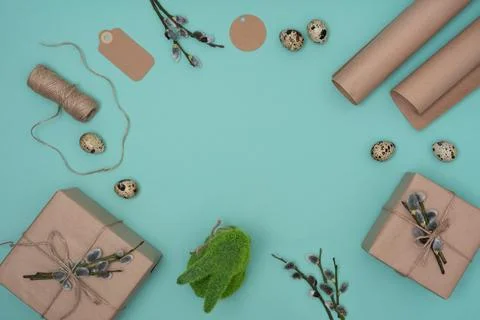 Pastel green easter background with gift box, willow tree branch, jute rope Stock Photos