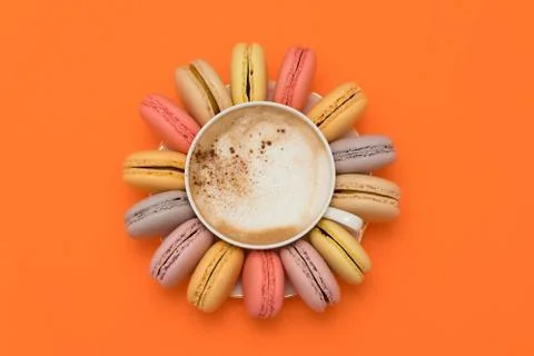 Pastel macarons around a coffee cup 스톡 사진